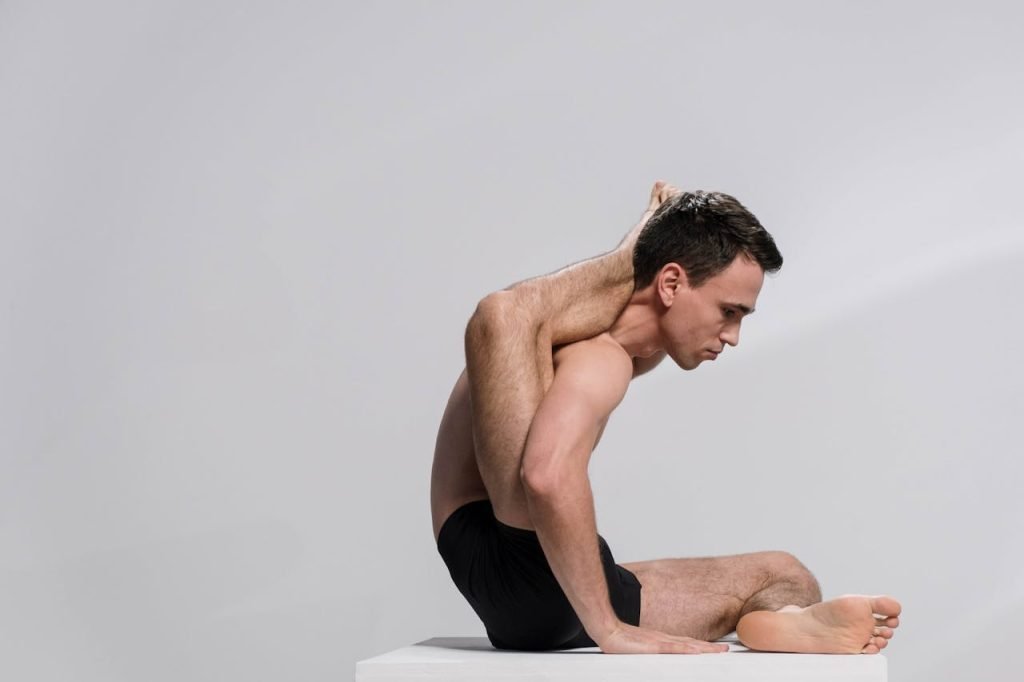 man lifting his leg on his shoulder and behind his head