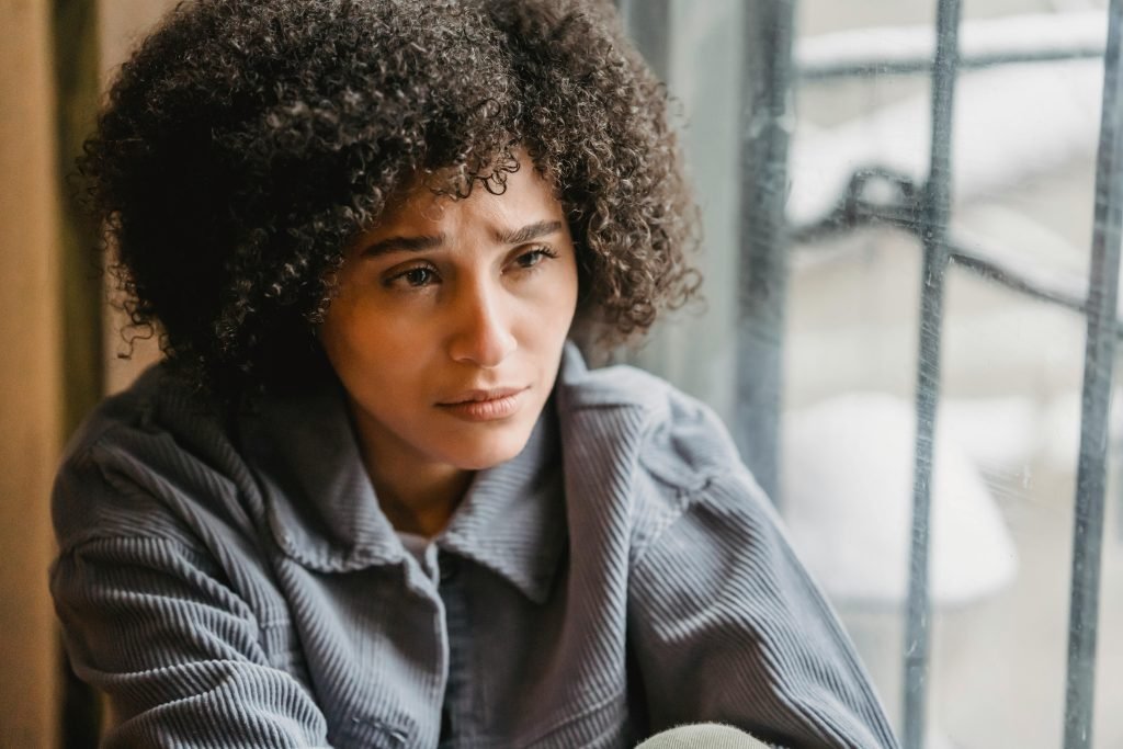 Photo by Liza Summer: https://www.pexels.com/photo/crying-helpless-black-woman-sitting-on-windowsill-6382589/