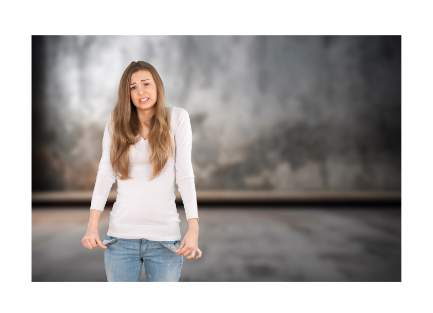 Woman in a white sweater and jeans pulls at her jeans with a worried expression against a blurred backdrop.