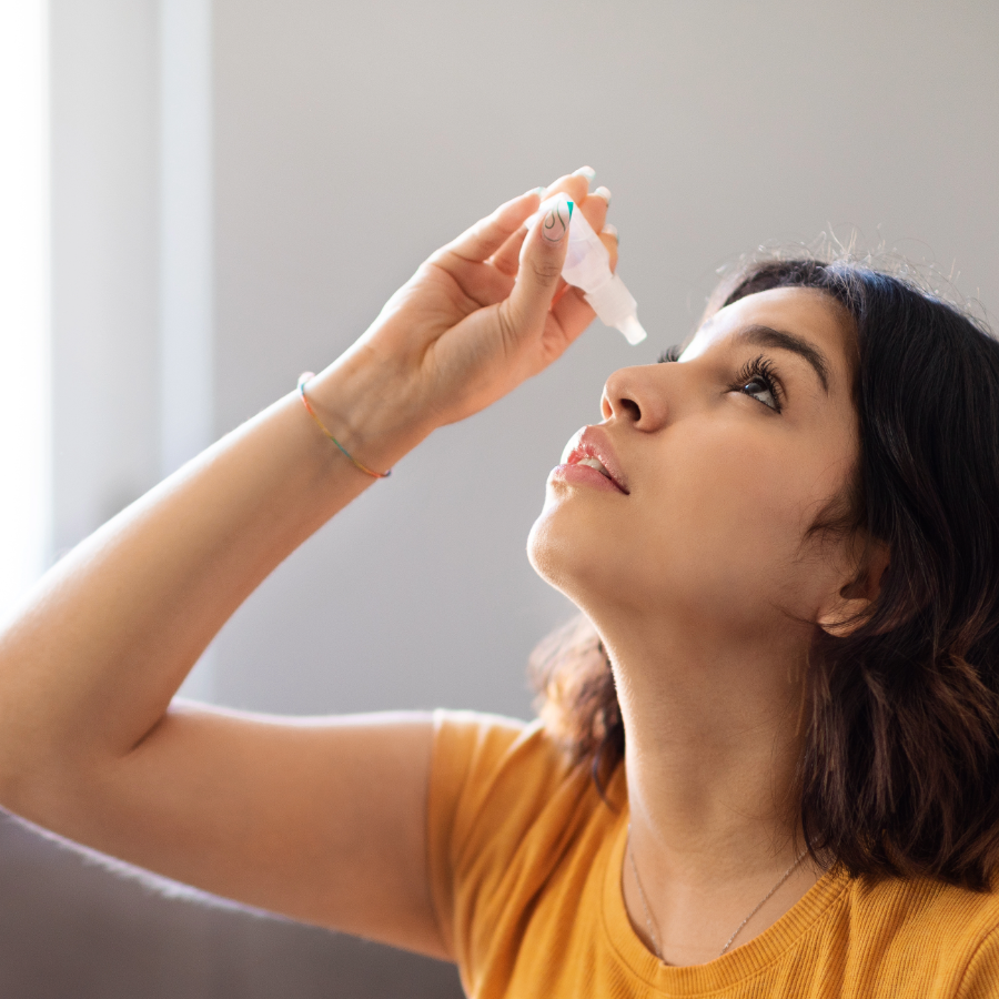 woman with Sjogren's disease uses eye drops